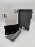 A white folio case with black charging stand and case-less spacer attachment