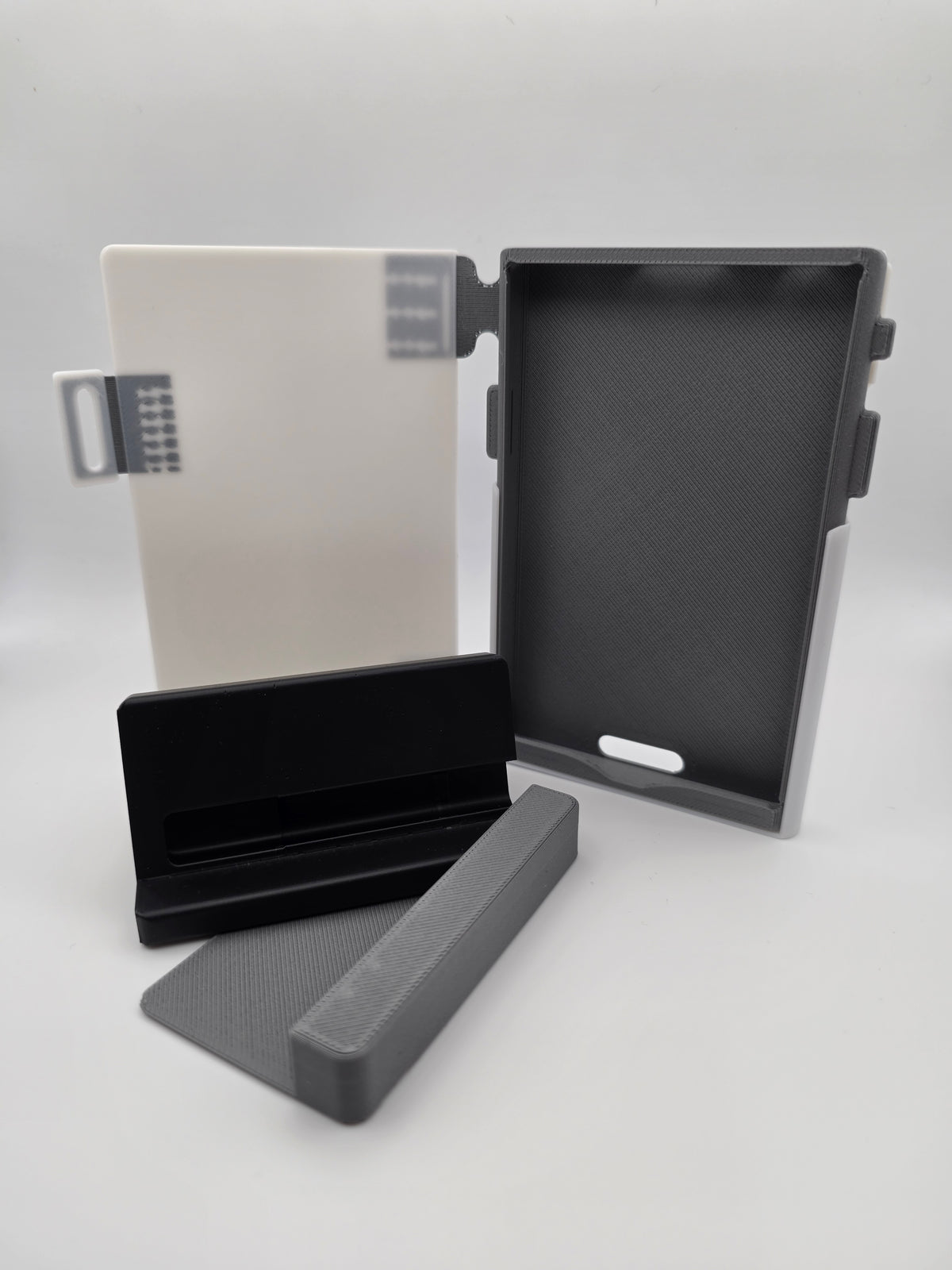 A white folio case with black charging stand and case-less spacer attachment