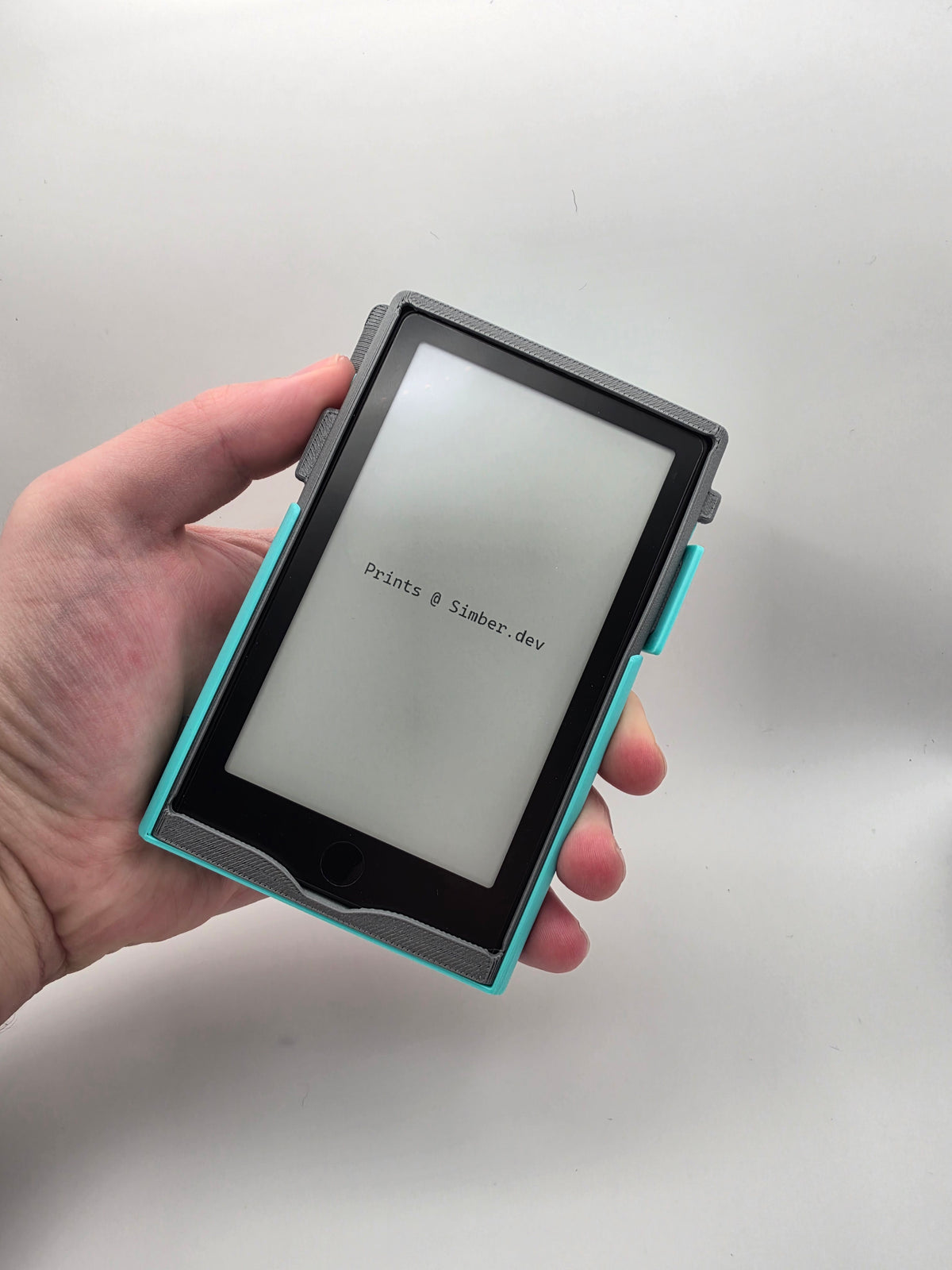 A folio case opened, in hand, shown from an point of view angle on a light gray background.
