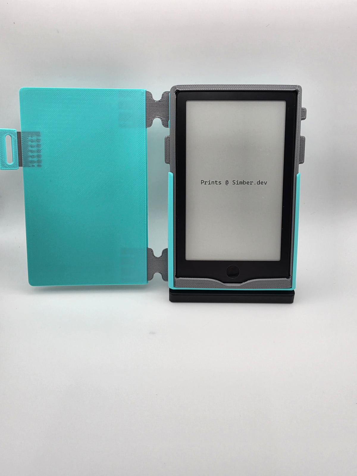 A light blue folio case, opened, resting on black charging stand.