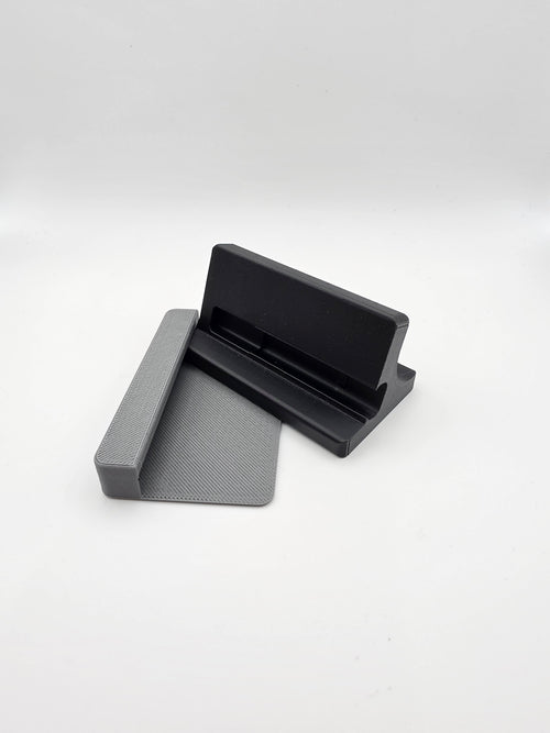 A black and gray 3D-printed stand, with the optional case-less device spacer attachment