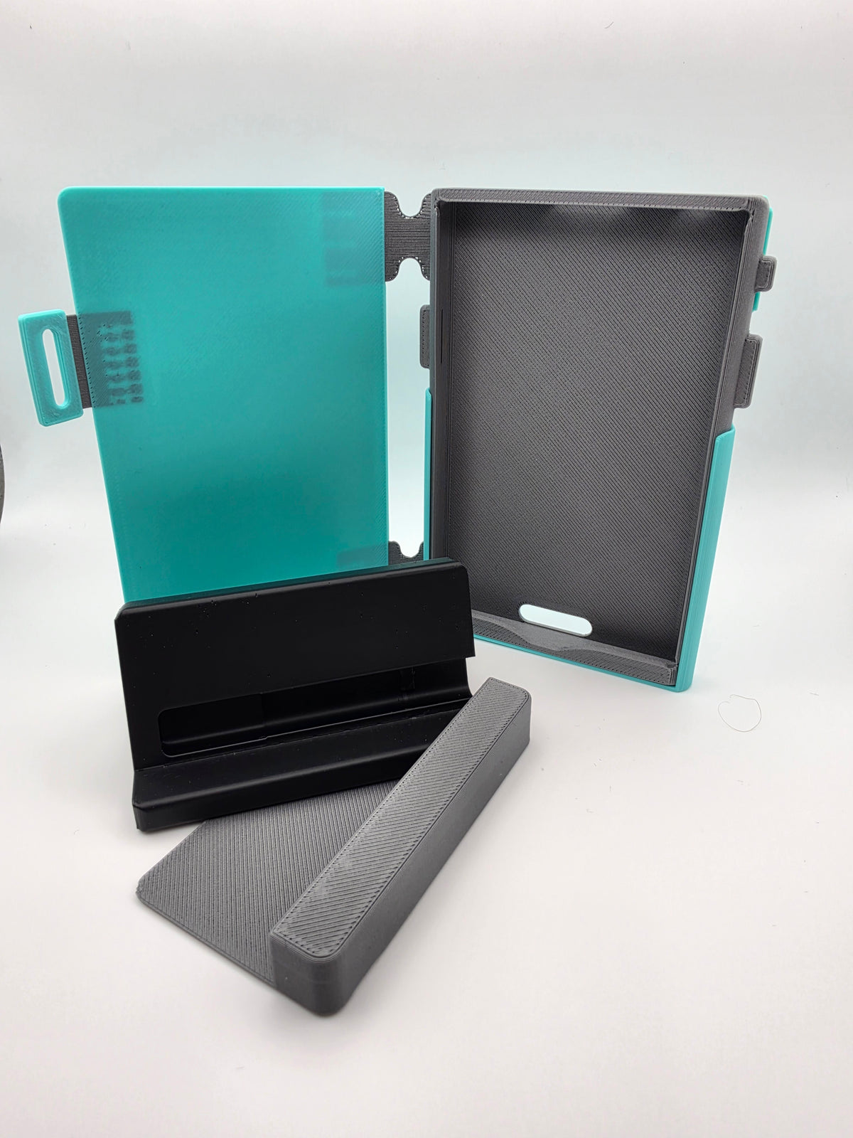A light blue folio case with black charging stand and case-less spacer attachment