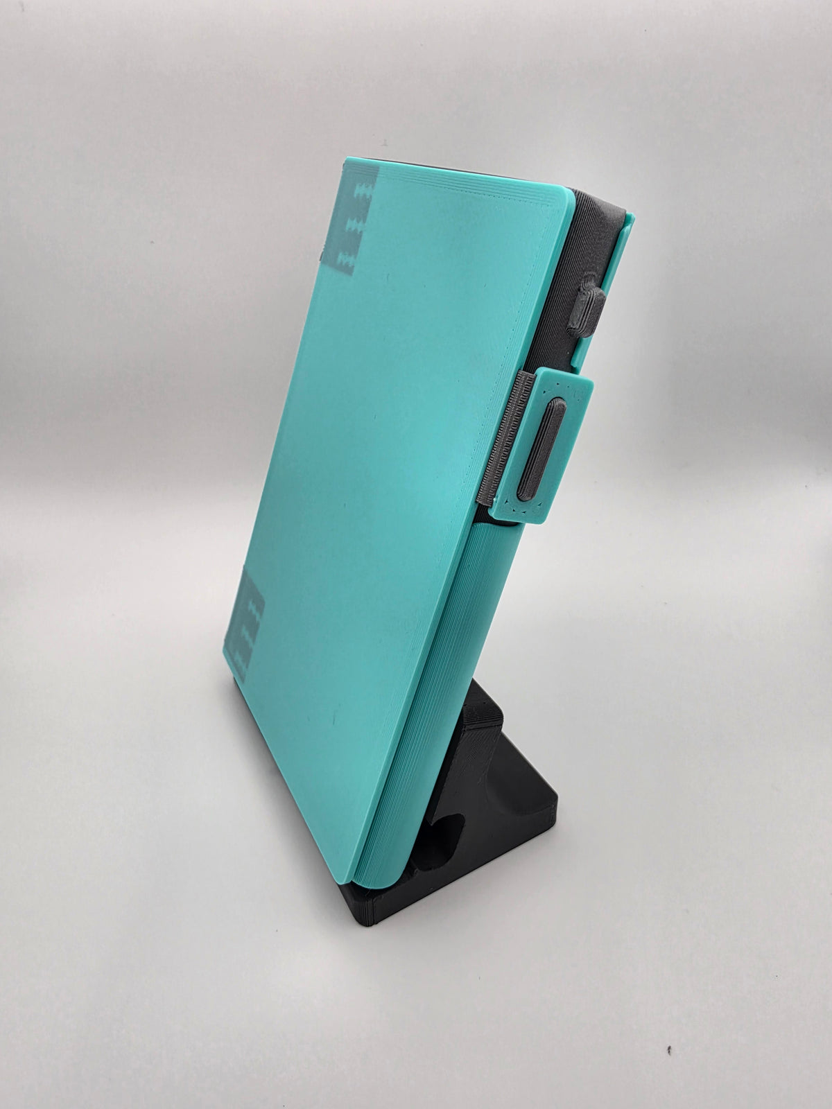 A light blue folio case resting on black charging stand.